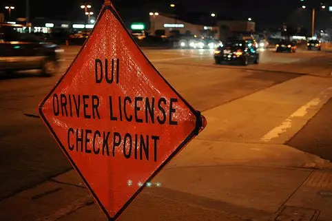 DUI driver license checkpoint sign at night illustrating DUI prevention and Florida traffic laws.