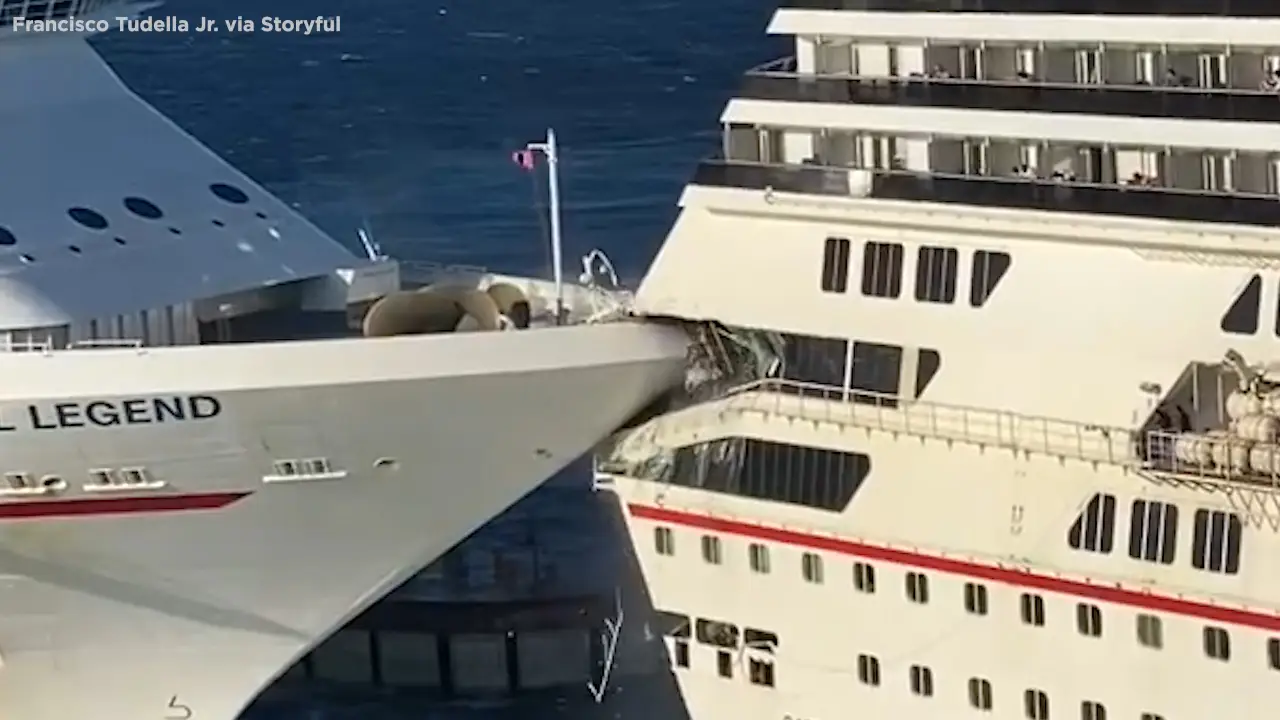 Carnival cruise ship collision with another vessel, showing damaged bow and structural impact, highlighting maritime safety concerns.