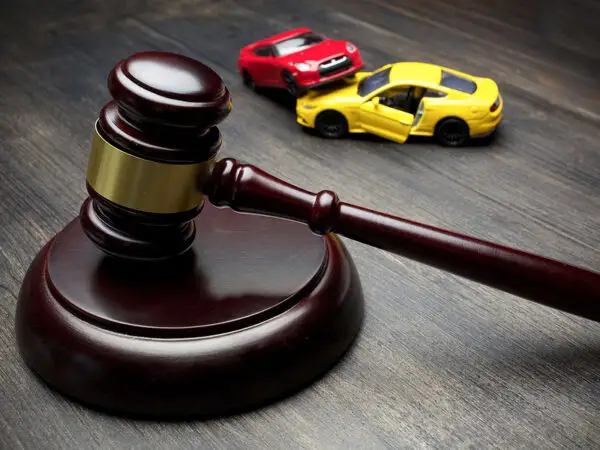 Gavel and toy cars representing legal matters related to car accidents and personal injury law.