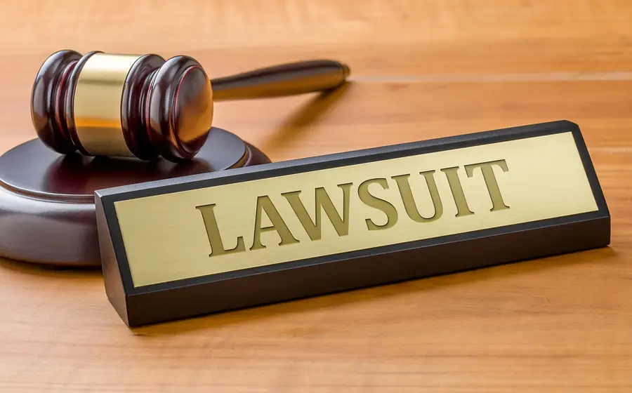 Gavel and nameplate labeled "LAWSUIT" symbolizing legal proceedings related to personal injury and cruise ship incidents.