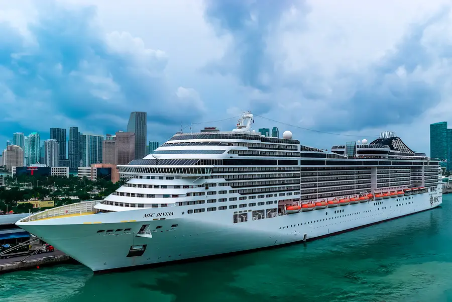 MSC Divina cruise ship docked in Miami, showcasing modern architecture against a cloudy skyline, representing the resurgence of cruise operations in the U.S. after the COVID-19 pandemic.