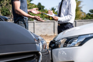 insurance agent examining car crash and customer assessed negoti