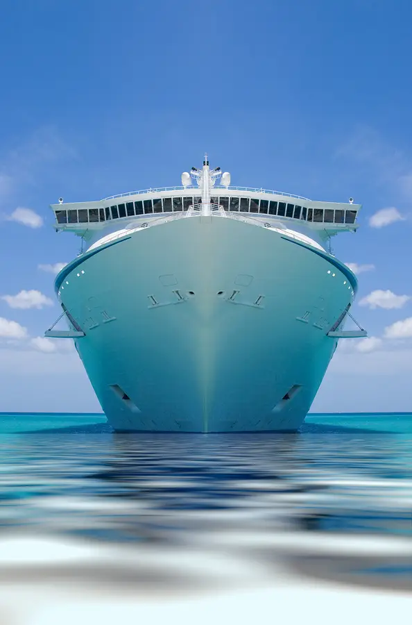 Cruise ship anchored in calm waters under a clear blue sky, representing Norwegian Cruise Line in the context of passenger rights and legal issues.