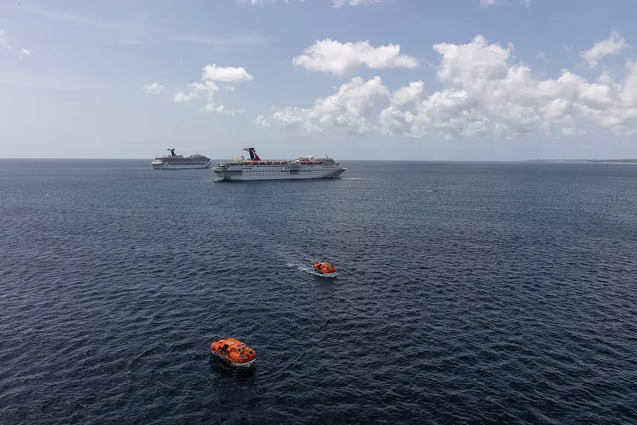 Carnival Cruise ships and rescue boat in ocean, illustrating maritime safety and incidents at sea.