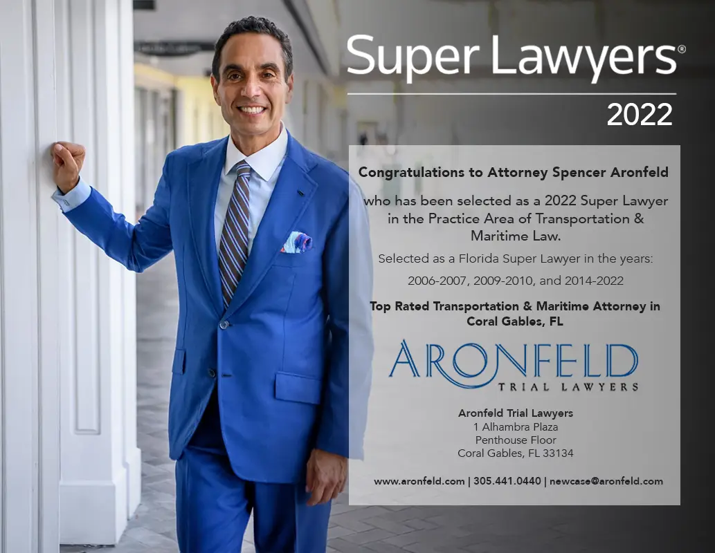 Attorney Spencer Aronfeld in a blue suit, smiling and leaning against a wall, featured as a 2022 Super Lawyer in Transportation and Maritime Law, representing Aronfeld Trial Lawyers.