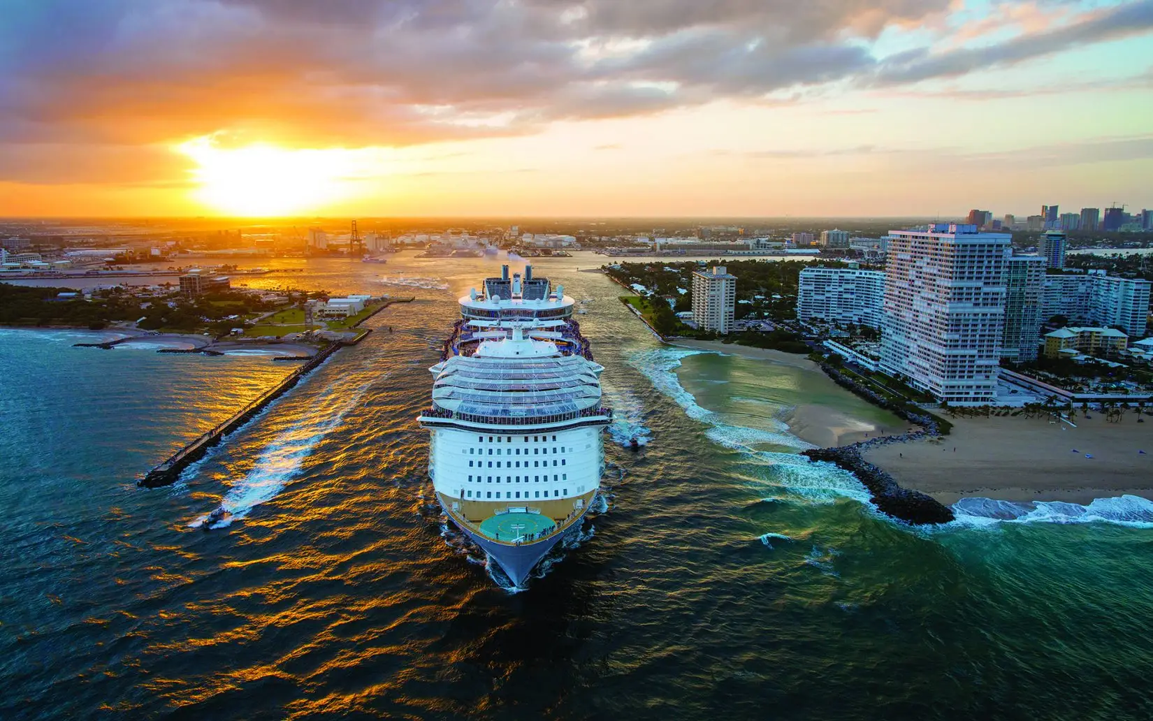 Royal Caribbean cruise ship departing PortMiami at sunset, showcasing the vibrant sky and coastal scenery, related to recent cruise industry updates and legal matters.