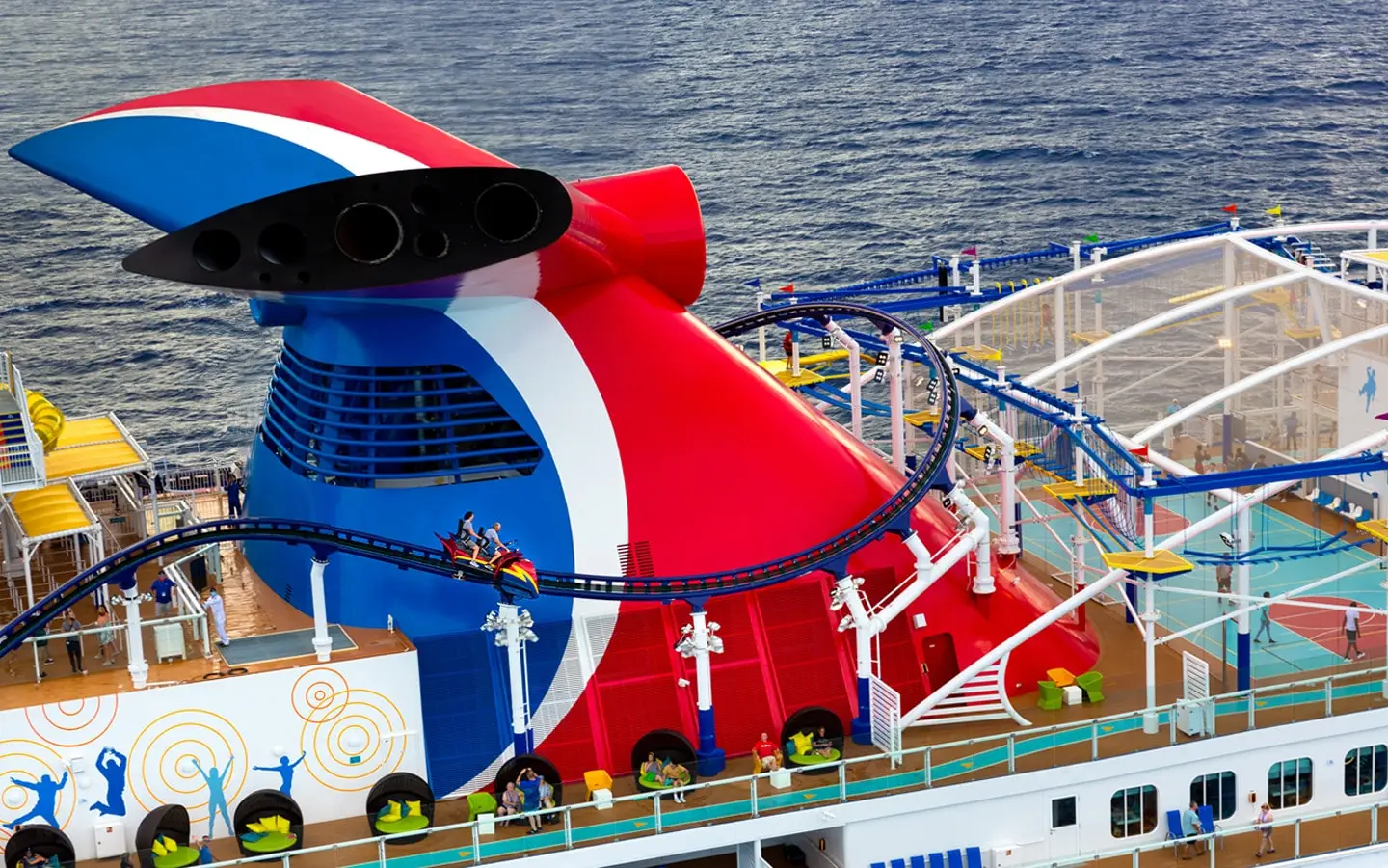 Carnival's Mardi Gras cruise ship featuring a colorful funnel and roller coaster above deck, showcasing innovative design and attractions for passengers.