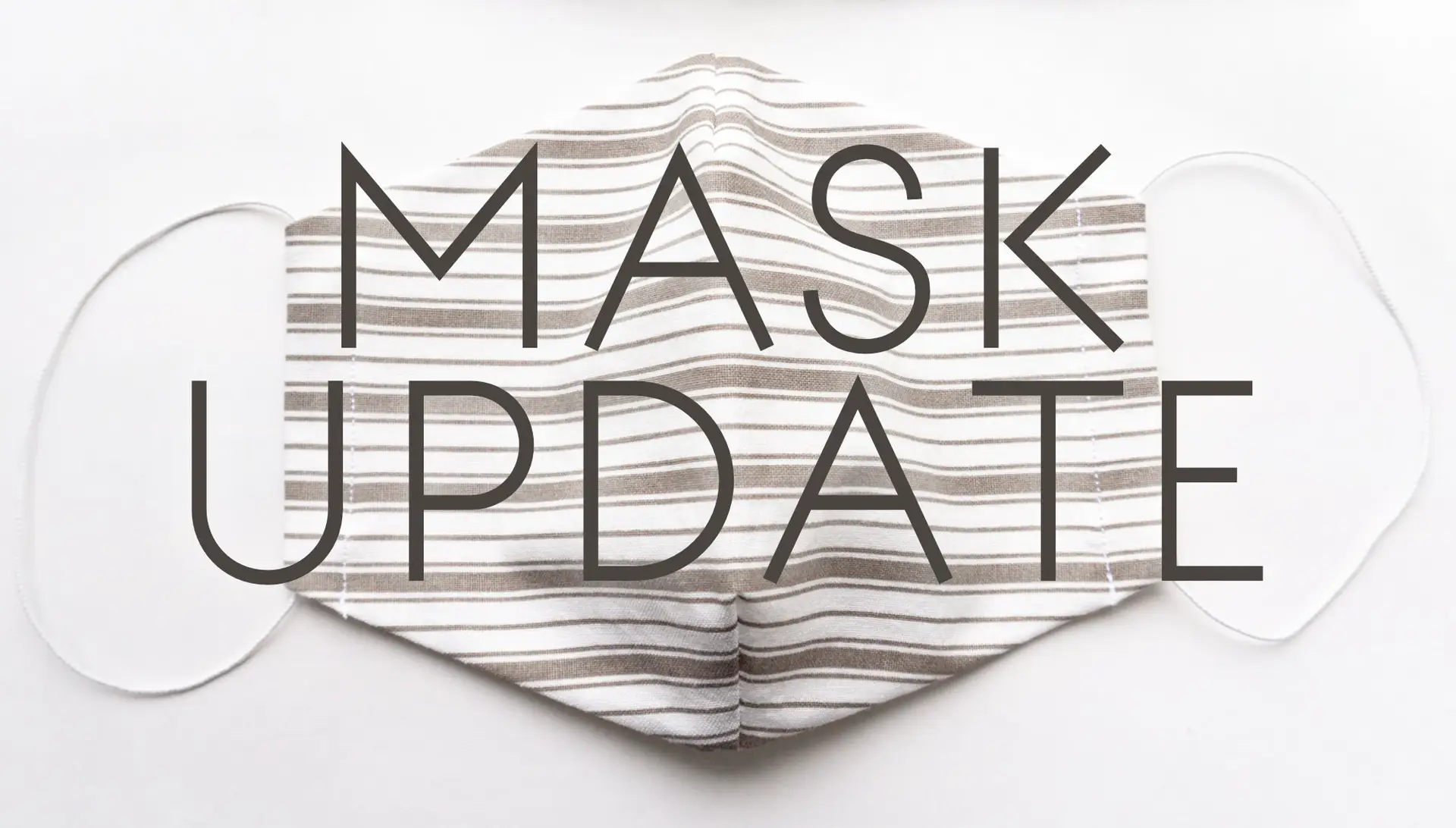 Mask update graphic featuring a striped cloth mask, relevant to cruise ship Covid-19 vaccination and safety protocols.