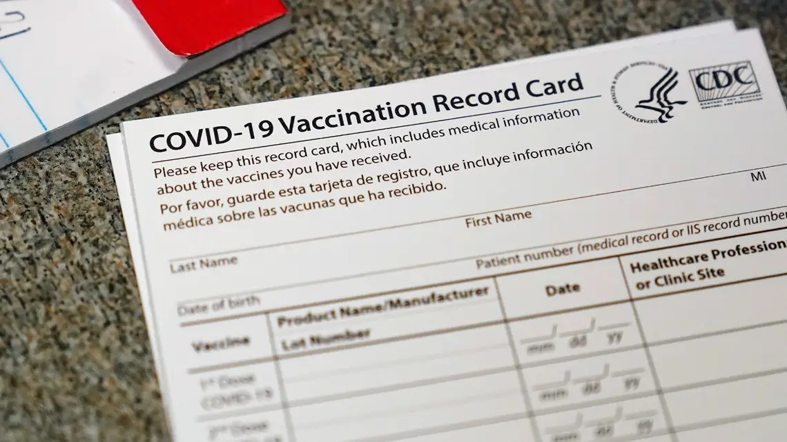 COVID-19 vaccination record card displaying essential medical information and vaccination details, relevant to cruise industry health protocols.