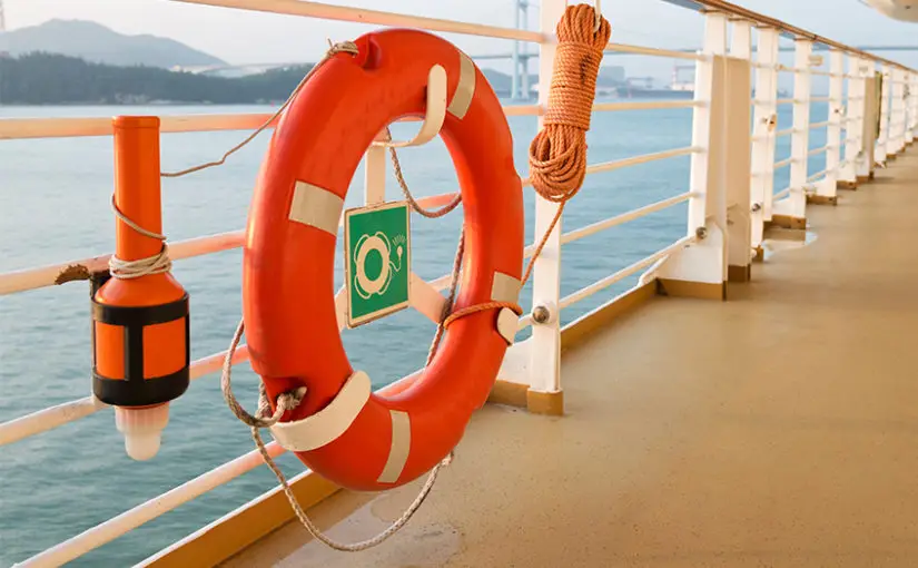 Lifebuoy and safety equipment on a cruise ship deck, emphasizing maritime safety and passenger protection.