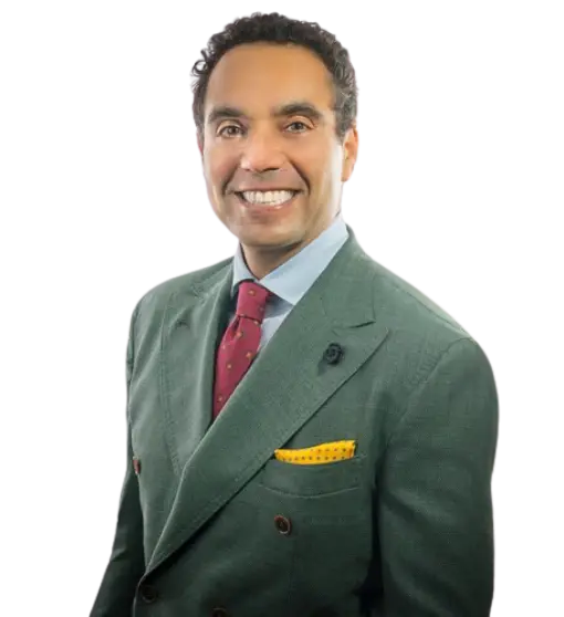 Spencer Aronfeld, founder of Aronfeld Trial Lawyers, smiling in a green suit with a yellow pocket square, representing expertise in personal injury law.