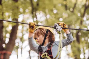 small boy enjoy childhood years. high ropes walk. cute school ch