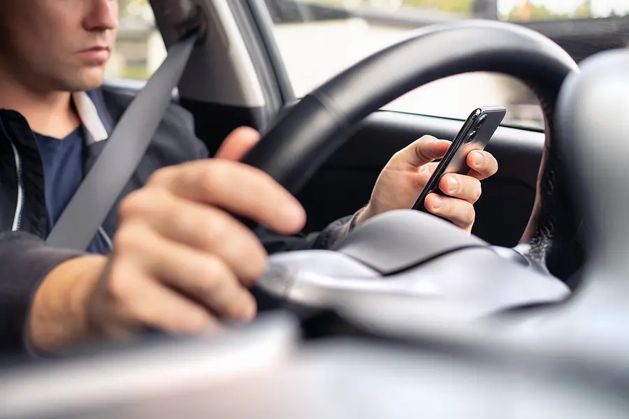 texting and driving a car. using mobile phone in traffic. distra
