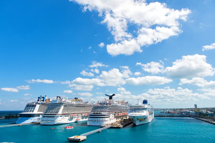 Cruise ships docked in port under a bright blue sky, highlighting the maritime setting relevant to cruise ship crime statistics and legal concerns.