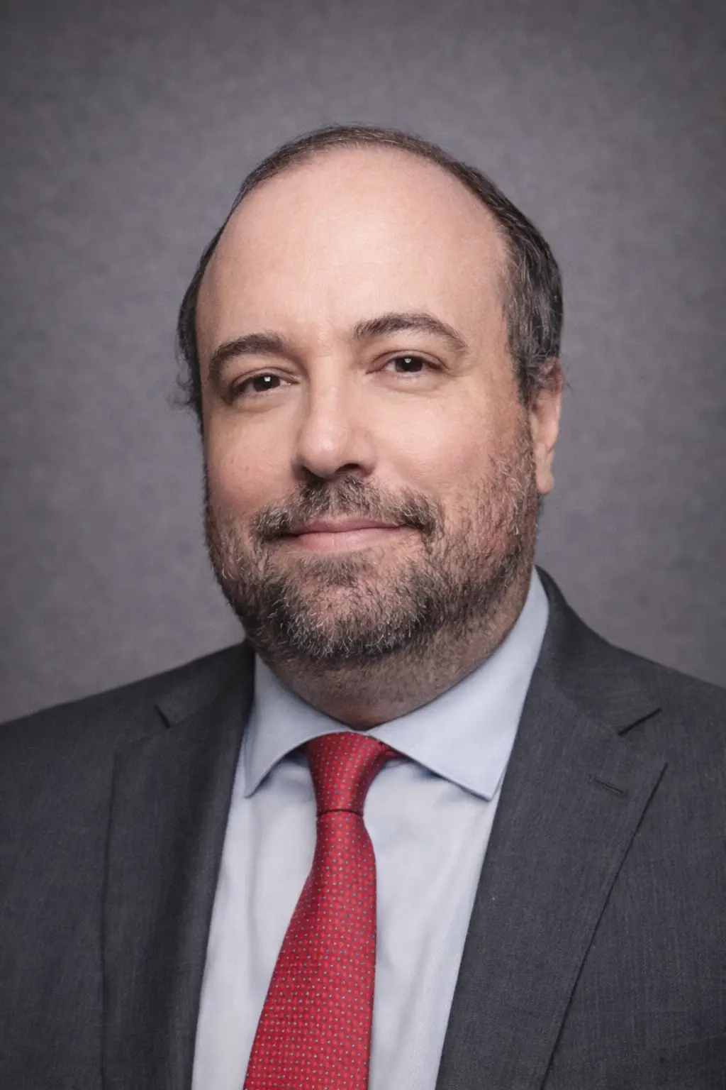 Professional portrait of Matthias Hayashi, Associate Attorney at Aronfeld Trial Lawyers, wearing a gray suit and red tie, against a neutral background, reflecting the firm's commitment to legal excellence and client representation.
