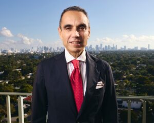 Spencer Aronfeld, attorney at Aronfeld Trial Lawyers, standing in a suit with Miami skyline in the background, representing legal expertise in personal injury and maritime law.