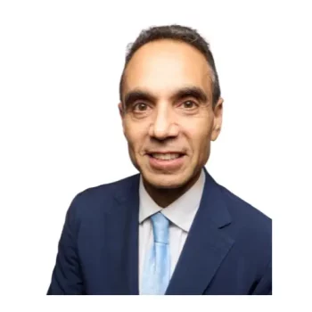 Spencer Aronfeld, Esq., founder of Aronfeld Trial Lawyers, smiling in a blue suit and light blue tie, representing expertise in personal injury law.